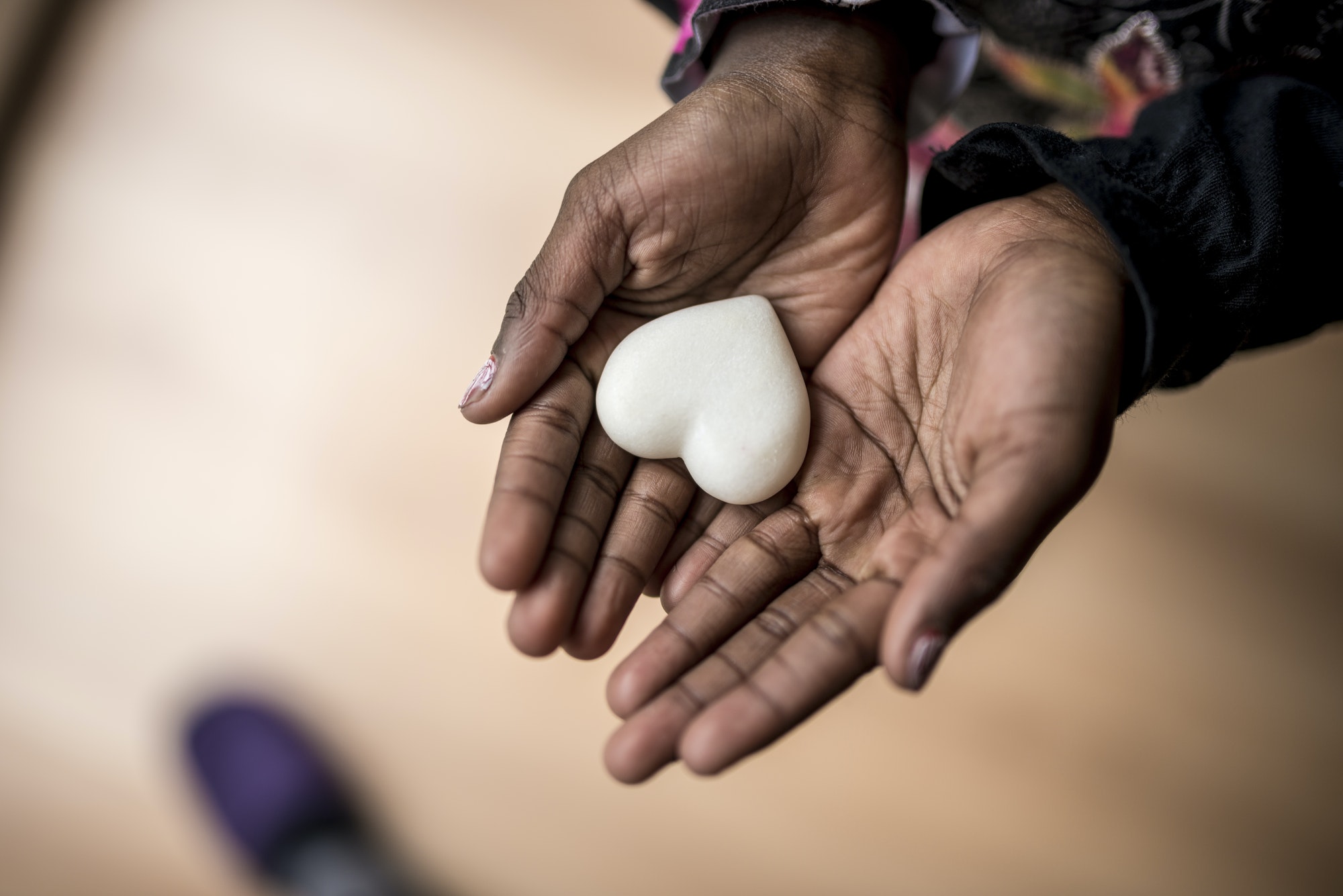 african-american-girl-hands-holding-a-marble-made-heart.jpg